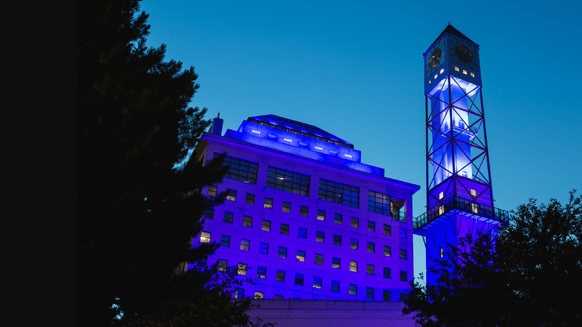 The Civic Centre clock tower lit blue, teal and gold.